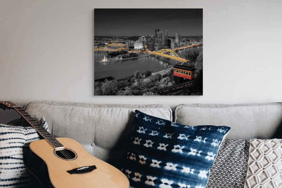 Fine Art Photography Metal Prints of Pittsburgh in black and gold hanging over a couch.